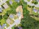 Aerial view showcases the house and backyard wooded area in a serene neighborhood cul-de-sac at 2605 Fort Apachee Trl, Dacula, GA 30019