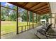 Relaxing back porch with rocking chairs and an expansive view of the yard and shed at 2605 Fort Apachee Trl, Dacula, GA 30019