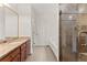 Well-lit bathroom featuring a granite countertop vanity, soaking tub, and glass-enclosed shower at 2605 Fort Apachee Trl, Dacula, GA 30019