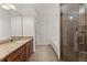 Well-lit bathroom featuring a granite countertop vanity, soaking tub, and glass-enclosed shower at 2605 Fort Apachee Trl, Dacula, GA 30019