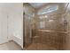 Bathroom featuring soaking tub and glass shower with small window at 2605 Fort Apachee Trl, Dacula, GA 30019