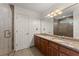 Bathroom featuring double sinks with granite countertops and a glass shower enclosure at 2605 Fort Apachee Trl, Dacula, GA 30019