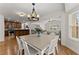 Dining room area open to the kitchen and living room offering natural light and stainless steel appliances at 2605 Fort Apachee Trl, Dacula, GA 30019