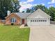 Charming single-story home featuring a brick facade, white siding, and a well-manicured lawn at 2605 Fort Apachee Trl, Dacula, GA 30019