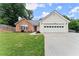 Charming single-story home featuring a brick facade, white siding, and a well-manicured lawn at 2605 Fort Apachee Trl, Dacula, GA 30019