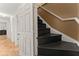 Hallway leading to stairs with black treads and a contrasting white railing at 2605 Fort Apachee Trl, Dacula, GA 30019