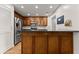 Kitchen featuring dark cabinets, stainless steel refrigerator, and dark countertop bar seating at 2605 Fort Apachee Trl, Dacula, GA 30019
