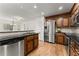 Modern kitchen with stainless steel appliances, granite counters, and view of open dining area at 2605 Fort Apachee Trl, Dacula, GA 30019