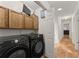 Laundry room with front load washer/dryer and cabinets above at 2605 Fort Apachee Trl, Dacula, GA 30019