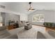 Bright living room featuring hardwood floors, a ceiling fan, and a large window for natural light at 2605 Fort Apachee Trl, Dacula, GA 30019