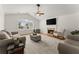 Bright living room featuring a fireplace, large window, and neutral decor at 2605 Fort Apachee Trl, Dacula, GA 30019