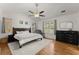 Main bedroom with vaulted ceiling, neutral walls, ceiling fan, and hardwood floors at 2605 Fort Apachee Trl, Dacula, GA 30019