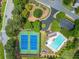 Aerial view of community amenities including a pool, tennis courts, playground, and lush landscaping at 2870 Tattersall Ct, Cumming, GA 30041