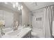 Bathroom featuring a single vanity, tub/shower combo with marble tile, and modern fixtures at 2870 Tattersall Ct, Cumming, GA 30041