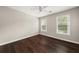Bedroom featuring hardwood floors, neutral paint, a ceiling fan, and natural light from the windows at 2870 Tattersall Ct, Cumming, GA 30041
