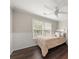 Comfortable bedroom with hardwood floors, neutral paint, wainscoting, and natural light from the windows at 2870 Tattersall Ct, Cumming, GA 30041