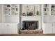 Close-up of fireplace with stone hearth and built-in bookshelves, combining warmth and style at 2870 Tattersall Ct, Cumming, GA 30041
