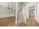 Welcoming foyer featuring a staircase, elegant chandelier, wainscotting, and hardwood floors at 2870 Tattersall Ct, Cumming, GA 30041