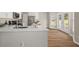 Bright kitchen with stainless steel appliances, quartz countertops, and white cabinets, complemented by hardwood floors at 2870 Tattersall Ct, Cumming, GA 30041