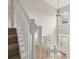 Staircase features white railing, carpeted stairs, and a view of the front entry with a chandelier and arched window at 2870 Tattersall Ct, Cumming, GA 30041