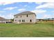 Exterior of home with a large grassy backyard and a cloudy sky above at 120 Aj Welch Jr Way, Mcdonough, GA 30252