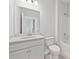 Bright bathroom featuring a white vanity, toilet, and shower-tub combination at 120 Aj Welch Jr Way, Mcdonough, GA 30252