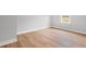 Empty bedroom features hardwood floors, white trim, a window, and neutral colored walls at 120 Aj Welch Jr Way, Mcdonough, GA 30252