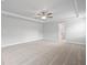 Spacious bedroom showcasing neutral carpeting, ceiling fan, and ensuite bathroom at 120 Aj Welch Jr Way, Mcdonough, GA 30252