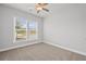 Cozy bedroom with neutral carpet, a ceiling fan, and natural light from the window at 120 Aj Welch Jr Way, Mcdonough, GA 30252