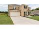 Side view of a two story brick home with a two car garage and a large driveway at 120 Aj Welch Jr Way, Mcdonough, GA 30252