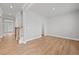 Bright living room featuring hardwood floors, neutral paint, and a staircase to upper level at 120 Aj Welch Jr Way, Mcdonough, GA 30252