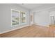 Light-filled room with large windows, hardwood floors, and a glimpse of an adjacent bathroom at 120 Aj Welch Jr Way, Mcdonough, GA 30252