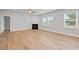Spacious living room featuring a fireplace, hardwood floors, and plenty of natural light at 120 Aj Welch Jr Way, Mcdonough, GA 30252