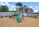 Community playground with slides, climbing structures, and a bench, all set on a wood chip surface at 120 Aj Welch Jr Way, Mcdonough, GA 30252