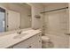 Bathroom featuring a tub and shower, a white single sink vanity with chrome faucet, and a large mirror at 3360 Pickens St, Duluth, GA 30096