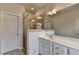 Bright bathroom featuring double vanity, large mirror and tiled shower with glass door at 3360 Pickens St, Duluth, GA 30096