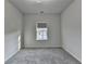 A simple yet cozy bedroom with gray carpeting and light-colored walls, offering a serene and neutral space at 3360 Pickens St, Duluth, GA 30096