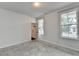 Bedroom featuring neutral colored walls, carpet, two large windows and closet at 3360 Pickens St, Duluth, GA 30096