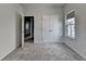 Inviting bedroom showcases double doors, a window, and plush gray carpeting, creating a comfortable and adaptable area at 3360 Pickens St, Duluth, GA 30096
