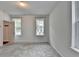 Bedroom with two large windows, neutral carpet, and a closet at 3360 Pickens St, Duluth, GA 30096