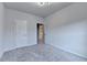 Bright, cozy bedroom with modern lighting, plush gray carpeting, and convenient access to other rooms through an open doorway at 3360 Pickens St, Duluth, GA 30096
