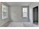 Bedroom with two windows, neutral carpet, and a closet at 3360 Pickens St, Duluth, GA 30096