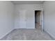 Comfortable bedroom with modern lighting, plush gray carpeting, and a doorway that provides seamless access to other areas at 3360 Pickens St, Duluth, GA 30096