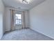 Bright, cozy bedroom with modern lighting and gray carpeting, complemented by a window draped with stylish curtains at 3360 Pickens St, Duluth, GA 30096