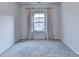 Serene bedroom with plush gray carpeting, complemented by soft, elegant curtains that frame the window at 3360 Pickens St, Duluth, GA 30096