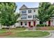 Charming townhome featuring a well-maintained lawn, brick facade, dark shutters and a red front door at 3360 Pickens St, Duluth, GA 30096