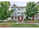 Charming townhome featuring a well-maintained lawn, brick facade, dark shutters and a red front door at 3360 Pickens St, Duluth, GA 30096