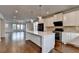 Modern kitchen features a large white center island, stainless steel appliances, and hardwood floors at 3360 Pickens St, Duluth, GA 30096