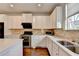 Modern kitchen features stainless steel appliances, a dual basin sink, and bright countertops at 3360 Pickens St, Duluth, GA 30096