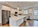 Open kitchen with stainless appliances, white cabinets, granite counters and wood floors at 3360 Pickens St, Duluth, GA 30096